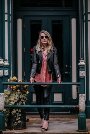 Portrait of strong woman in leather jacket, leggings, sunglasses and silk  bandana Stock Photo - Alamy