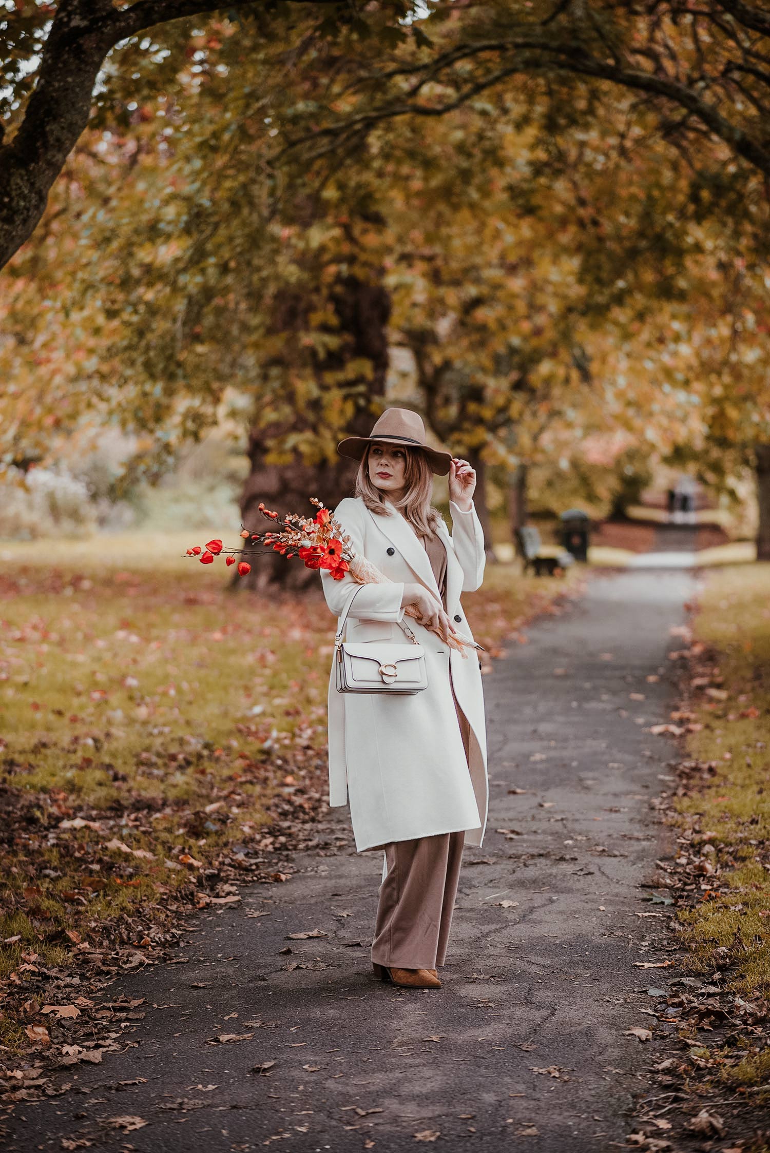 floral jumpsuit with ankle boots and a hat for fall