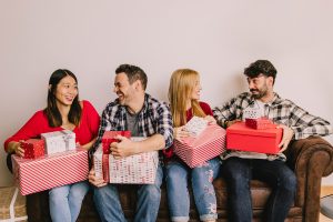 four friends on couch with gift boxes