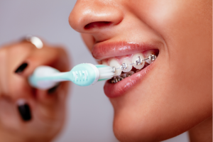 close-up-of-a-person-with-metal-braces-brushing-their-teeth-using-a-soft-toothbrush-highlighting-proper-oral-hygiene-during-orthodontic-treatment